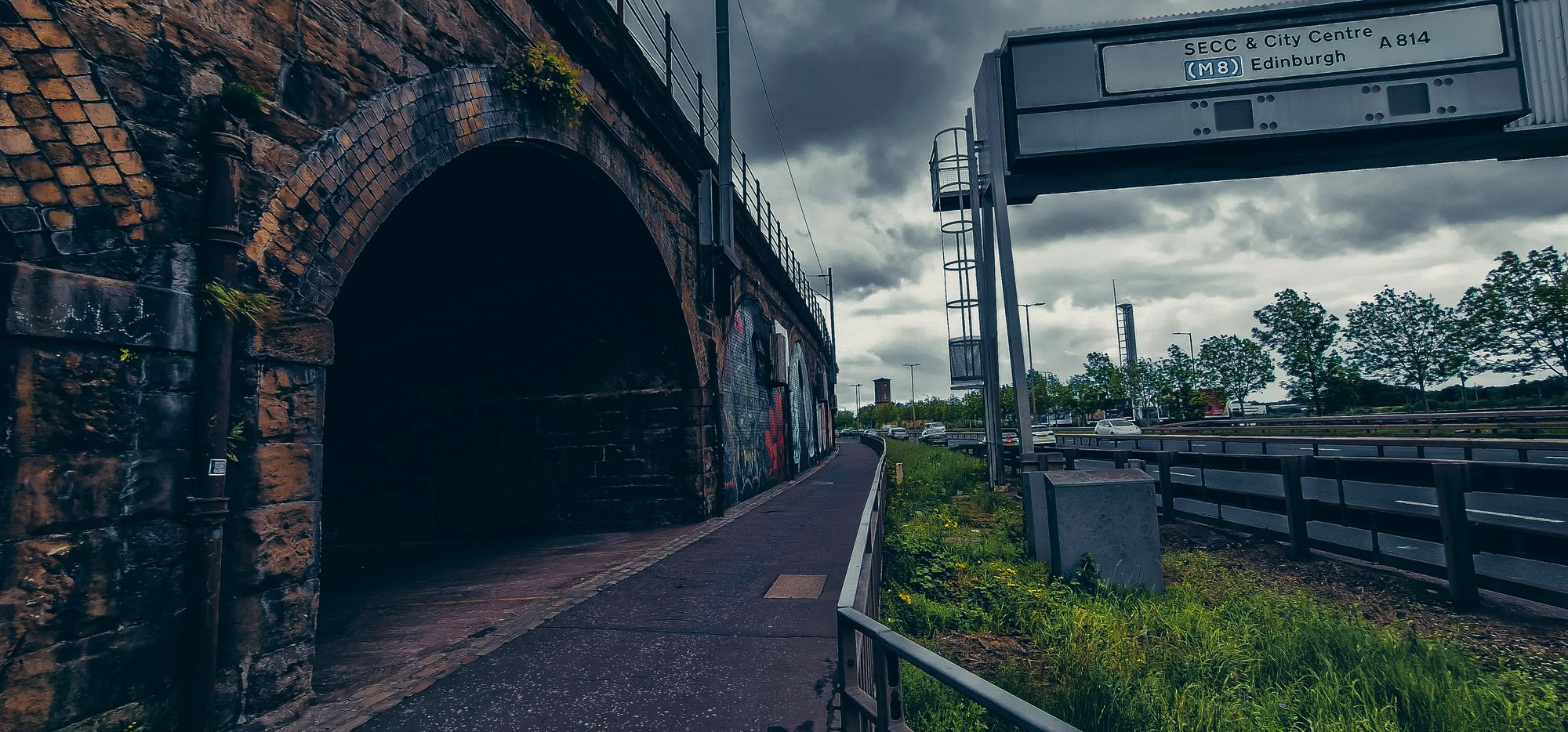Moody photo of railway arches with graffiti